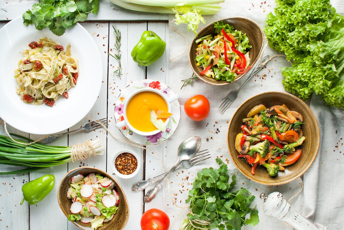 A colorful vegetarian meal spread on a wooden table.